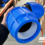 Close-up of a hands inserting a plastic pipe stiffener liner into a 25mm black MDPE water pipe before assembling a mechanical compression fitting.