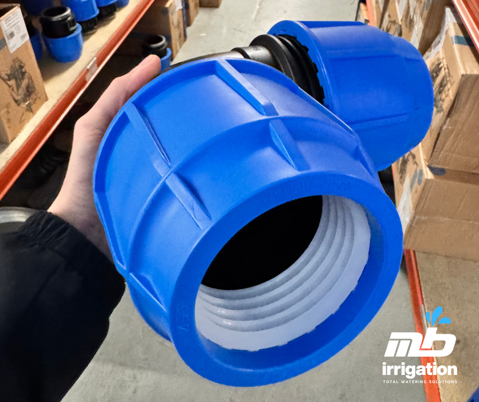 Close-up of a hands inserting a plastic pipe stiffener liner into a 25mm black MDPE water pipe before assembling a mechanical compression fitting.