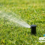 Gear-driven rotor pop-up lawn sprinkler spraying